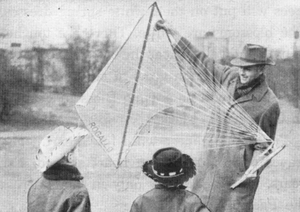 Rogallo showing kids a bi-conical kite with many strings.