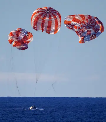 May 2026 - Artemis comes back from around the moon and touchdown under conventional parachutes.
